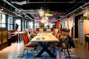 a dining room with a table and chairs and tables and chairsktop at Moxy The Hague in The Hague