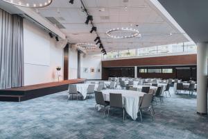 a banquet hall with white tables and chairs at Courtyard by Marriott Stockholm Kungsholmen in Stockholm
