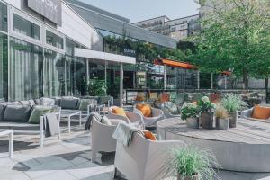 a patio with chairs and tables in front of a building at Courtyard by Marriott Stockholm Kungsholmen in Stockholm