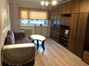 a living room with a couch and a table at Ahtme mnt apartaments in Ahtme +8 photos