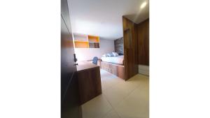 a hotel room with a bed and a bathroom at Habitaciones para mujeres en apartamento Acceso a cocina equipada, baño y lavandería in Tunja
