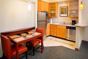 a small kitchen with a table and a refrigerator at Residence Inn by Marriott Roanoke Airport in Roanoke