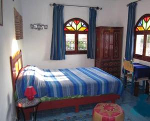 En eller flere senger på et rom på Auberge Casa Linda