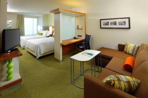 a hotel room with a bed and a couch at SpringHill Suites by Marriott Pittsburgh Latrobe in Latrobe