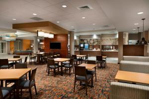 a restaurant with tables and chairs and a bar at Fairfield Inn & Suites by Marriott Rock Hill in Rock Hill