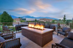 a fire pit on a patio with chairs at TownePlace Suites Salt Lake City Murray in Murray