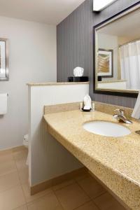 a bathroom with a sink and a mirror at Courtyard Pittsburgh Greensburg in Greensburg