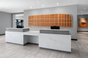 a lobby with a white counter at AC Hotel by Marriott Santa Rosa Sonoma Wine Country in Santa Rosa