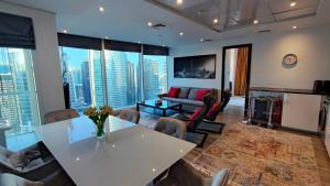 a living room with a white table and chairs at Modern & Spacious 2-Bed Condo with Panoramic Lake Views, Dual Balconies, Steps from Dubai JLT Metro By "La Buena Vida Holiday Homes" in Dubai