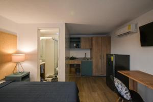 una camera con letto e una cucina con tavolo di Expo Satelite Hotel & Suites a Guadalajara