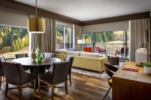 a living room with a couch and a table and chairs at The Josie Hotel, Autograph Collection in Rossland