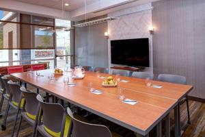 a large conference room with a large table and chairs at SpringHill Suites by Marriott Grand Rapids West in Grandville