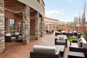 an outdoor patio with couches and tables and chairs at Courtyard by Marriott Boston Dedham/Westwood in Westwood