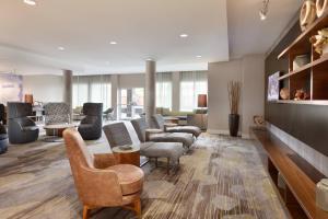 a living room with chairs and a waiting room at Courtyard by Marriott Boston Dedham/Westwood in Westwood