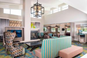 a living room with a couch and chairs and a tv at Residence Inn by Marriott Houston City Place in Spring