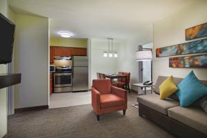 a living room with a couch and a kitchen at Residence Inn Houston by The Galleria in Houston