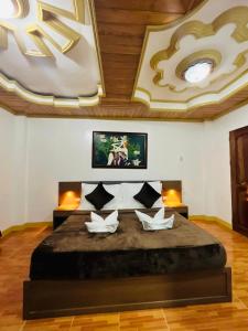 a bedroom with a large bed with a large ceiling at Villa Marii in Dipolog