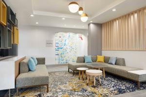 a waiting room with couches and a table at TownePlace Suites by Marriott Tampa Casino Area in Tampa