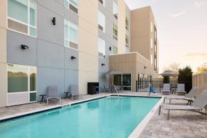 a swimming pool in front of a building at TownePlace Suites by Marriott Tampa Casino Area in Tampa