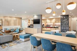 a cafeteria with a table and chairs and a kitchen at TownePlace Suites by Marriott Tampa Casino Area in Tampa