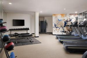 a gym with cardio equipment and a flat screen tv at Spring Hill Suites Minneapolis-St. Paul Airport/Mall Of America in Bloomington