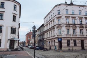 a city street with buildings and people walking on the street at Kraków Old Town - Kazimierz Dajwór in Kraków