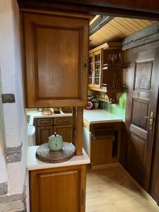 a kitchen with wooden cabinets and a teapot on the counter at Entire cozy chalet in St-Cergue - 30 min from Geneva in Saint-Cergue