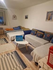 ein Wohnzimmer mit 3 Betten und einem Sofa in der Unterkunft Kerékpáros és Zarándok Vendégház in Apostag