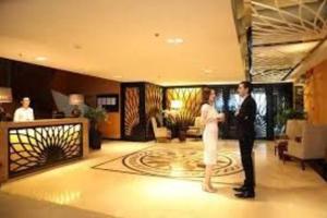 a man and woman dancing in a hotel lobby at The Rixx Convenient Apartment @ Ben Thanh/pool/gym in Ho Chi Minh City