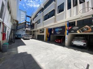 a building with a garage with cars parked in it at Hotel Podocarpus in Loja