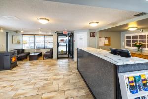 an office lobby with a counter and a living room at Econo Lodge Miramichi in Miramichi