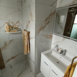 a white bathroom with a sink and a mirror at Villa Aleksandar in Protaras