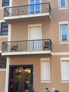 a apartment building with a balcony and a door at Appartamento Tevere in Finale Ligure