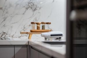 a kitchen counter with a appliance on a counter top at Skanderbeg Square Modern App - THE NEST in Tirana +16 photos