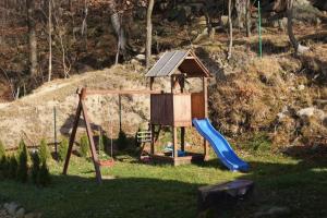 a playground with a slide and a play house at Domek w Karkonoszach 1 pod Karpaczem in Karpacz