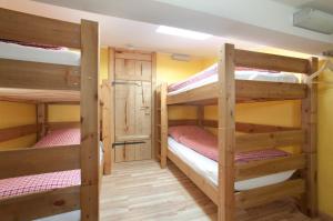 a room with three bunk beds in a cabin at Sonnenalm Kampenwand in Aschau im Chiemgau