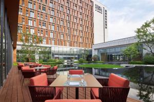 a restaurant with tables and chairs and a building at Four Points by Sheraton Nanchang, Xihu in Nanchang