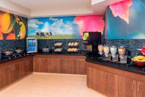 a restaurant with a counter with food on it at Fairfield Inn & Suites Tyler in Tyler
