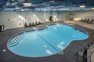 a large swimming pool in a building with chairs at Fairfield Inn & Suites by Marriott Belleville in Belleville