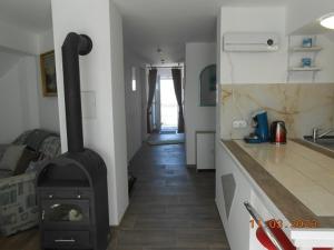 a kitchen with a stove in the middle of a room at Bei Hanna in Enying +10 photos