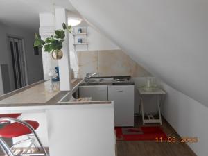 a small kitchen with a sink and a stove at Bei Hanna in Enying