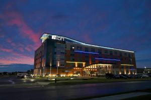a hotel building with a sign on the top of it at Aloft Tulsa in Tulsa