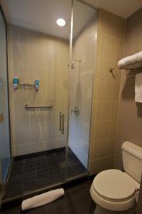 a bathroom with a shower and a toilet at Aloft Tulsa in Tulsa