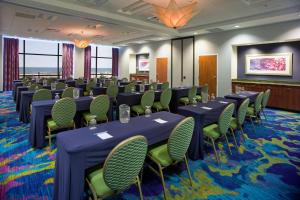 a conference room with tables and chairs in a room at SpringHill Suites by Marriott Virginia Beach Oceanfront in Virginia Beach