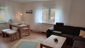 a living room with a couch and a table at Leimbach in Bad Brückenau