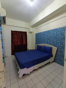 a bedroom with a blue bed in a room at Paradise Seaview Homestay in Port Dickson +58 photos