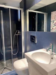 a bathroom with a sink and a toilet and a shower at Casa Vacanze Armanda in Lerici