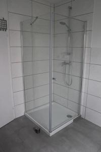 a shower with a glass door in a bathroom at Gästewohnung Pakulies in Weinheim