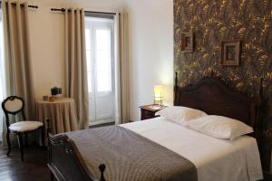 a bedroom with a large bed and a window at Mont' Sobro House in Évora