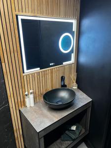 a bathroom with a black bowl sink on a counter at Luxe City Hot Tub: Urban Retreat in Norwich